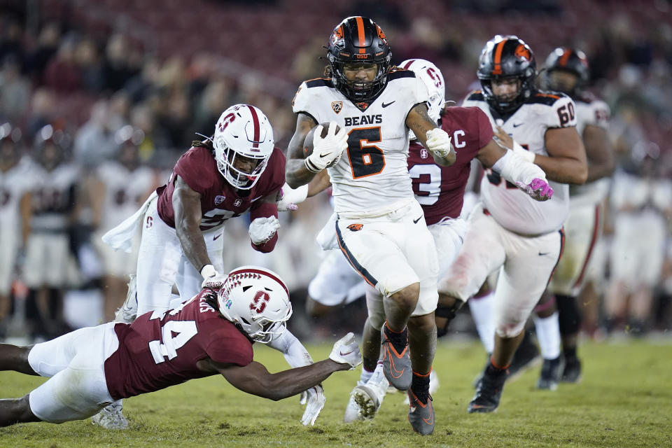 Oregon State running back Damien Martinez (6) runs the ball for a 43-yard touchdown as Stanford safety Patrick Fields (24) tries to tackle him during the second half of an NCAA college football game in Stanford, Calif., Saturday, Oct. 8, 2022. (AP Photo/Godofredo A. Vásquez)