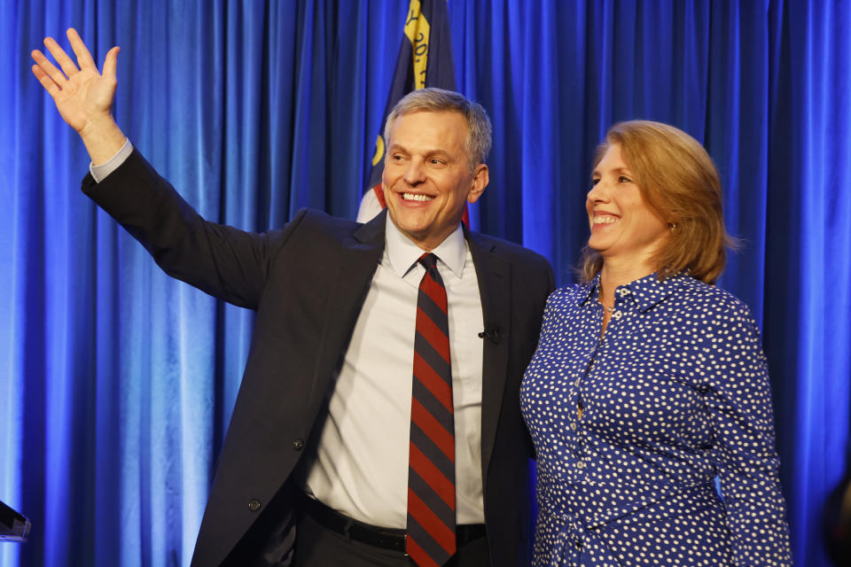 Democratic North Carolina gubernatorial candidate Josh Stein, left, is joined on stage by his wife Anna Harris Stein at a primary election night party in Raleigh, N.C., Tuesday, March 5, 2024. (AP Photo/Karl B DeBlaker)