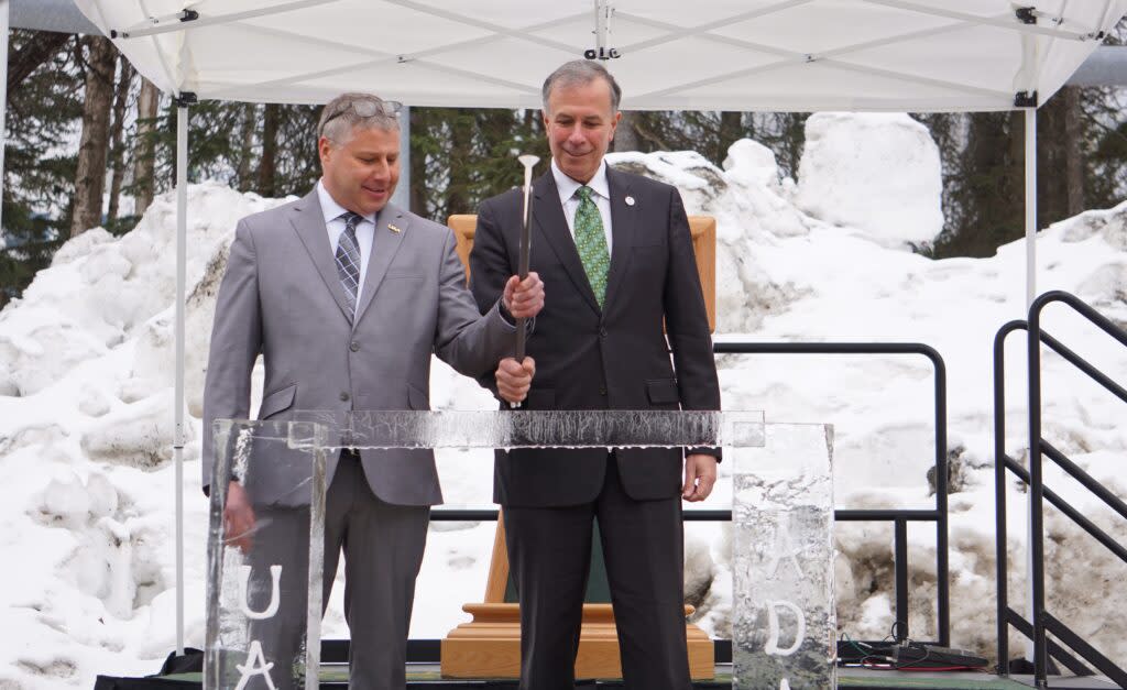 Jeff Libby, a University of Alaska assistant professor, and Dimitri Kusnezov, undersecretary for science and technology at the U.S. Department of Homeland Security, wield a hammer to break a span of ice at an April 9 campus ceremony marking the startup of the new ADAC-ARCTIC research center, which Libby heads. The new organization is one of the Department of Homeland Security's nine operating Centers of Excellence. (Photo by Yereth Rosen/Alaska Beacon)