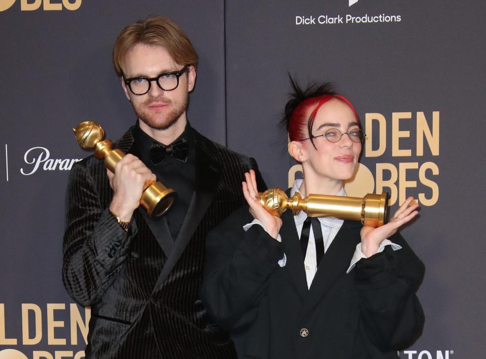 Billie Eilish (right) and brother Finneas O'Connell win for best original song at the Golden Globes.
