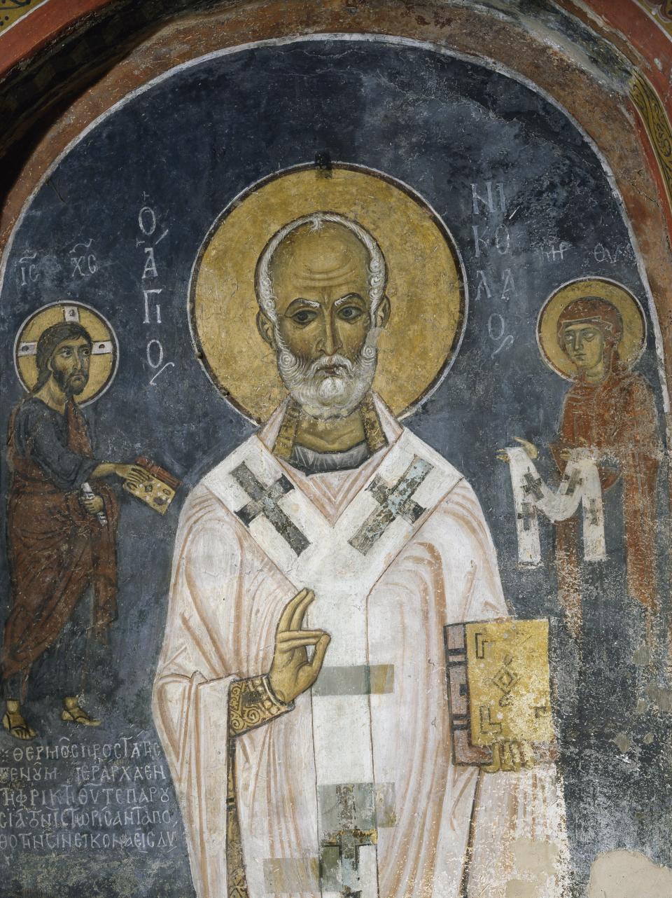 St. Nicholas of Myra is seen in this 12th-century fresco. The saint's acts of generosity, particularly to children, inspired the red and white-suited&nbsp;figure&nbsp;known as Santa Claus. (Photo: DEA / A. DAGLI ORTI via Getty Images)