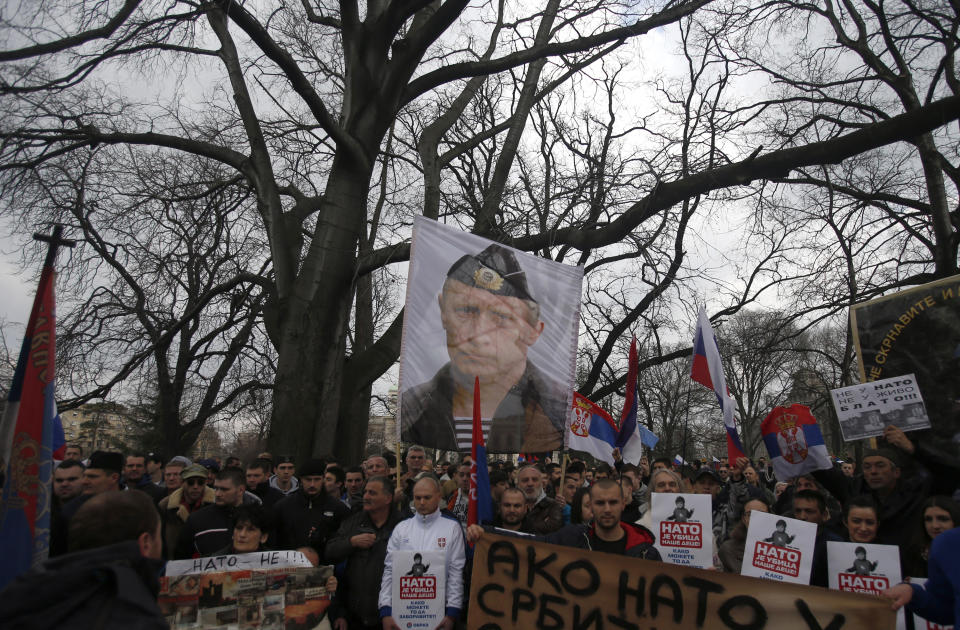 FILE - In this Saturday, Feb. 20, 2016 file photo, protesters hold a picture of Russian President Vladimir Putin during a protest against NATO in downtown Belgrade, Serbia. Vladimir Putin has accused the U.S. and the West of destabilizing the Balkans with NATO expansion policies as Serbia prepares a hero's welcome for the Russian president. (AP Photo/Darko Vojinovic, File)