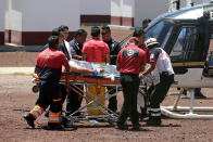 <p>Paramedics wheel a stretcher carrying a man injured due to fireworks explosions toward a helicopter in the municipality of Tultepec, on the outskirts of Mexico City, Mexico July 5, 2018. (Photo: Daniel Becerril/Reuters) </p>