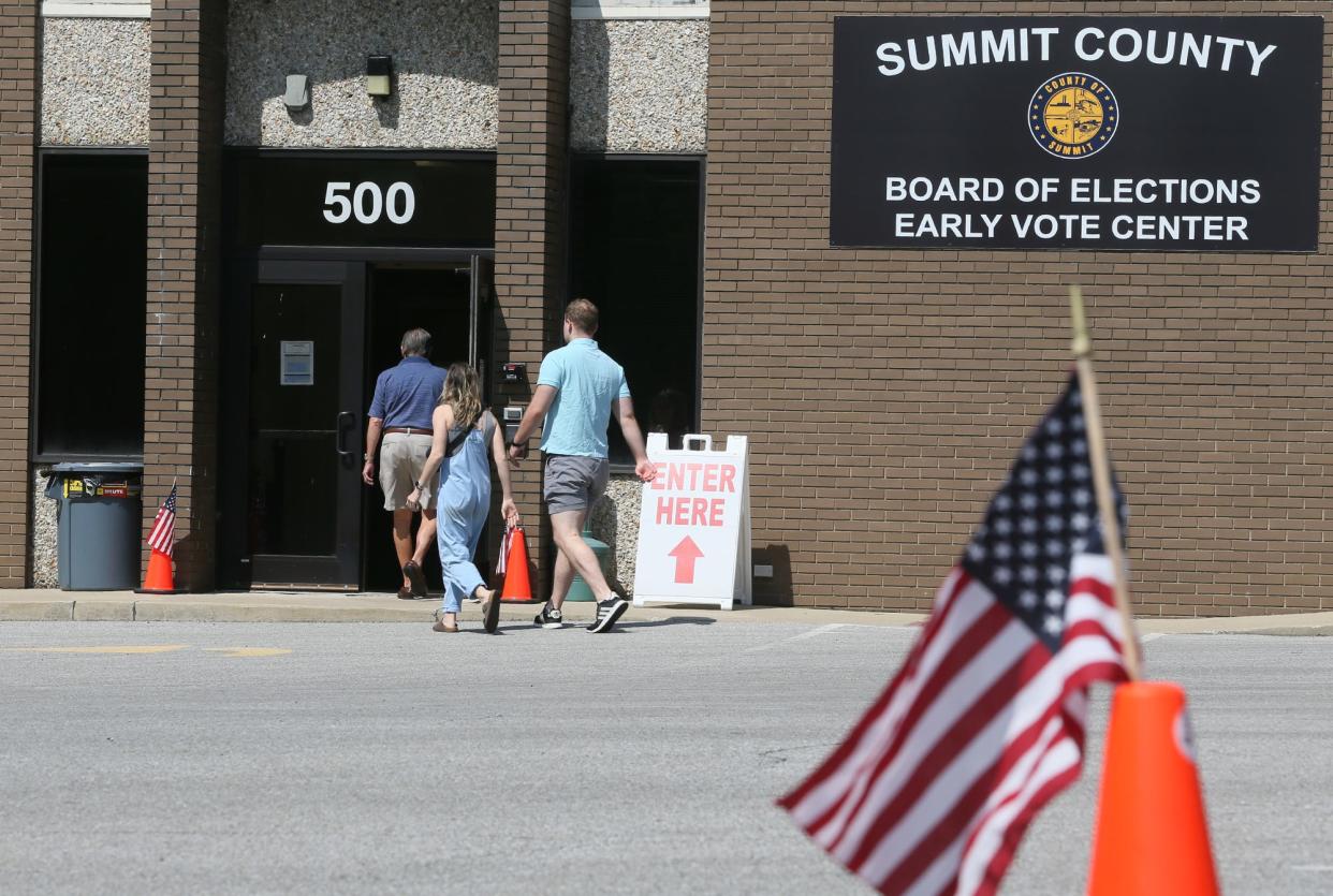 Voters enter the Summit County Board of Election Early Voting Center to vote on Issue 1 in Akron.
