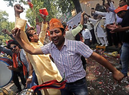 Supporters of the India's Bharatiya Janata Party (BJP) celebrate after learning of the poll results outside the party headquarters in New Delhi May 16, 2014. REUTERS/Adnan Abidi