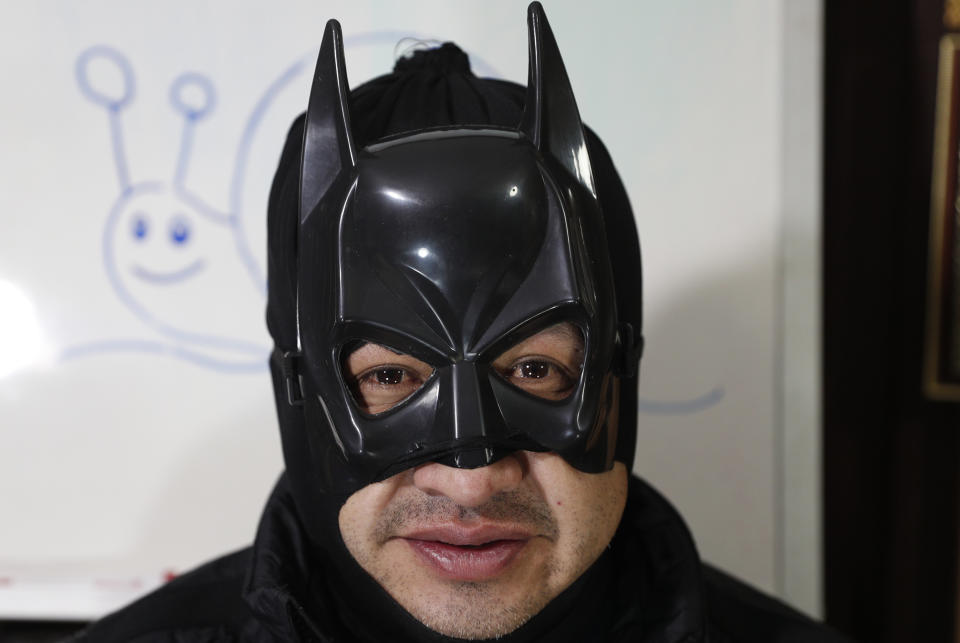 Art teacher Jorge Manolo Villarroel, wearing a Batman costume, poses for a photo at his home during one of his online classes, amid the new coronavirus pandemic, in La Paz, Bolivia, Tuesday, June 9, 2020. The class begins with a Zumba-style warm-up (Villarroel is also a Zumba instructor), followed by a prayer and then superhero music, to set the proper atmosphere. (AP Photo/Juan Karita)