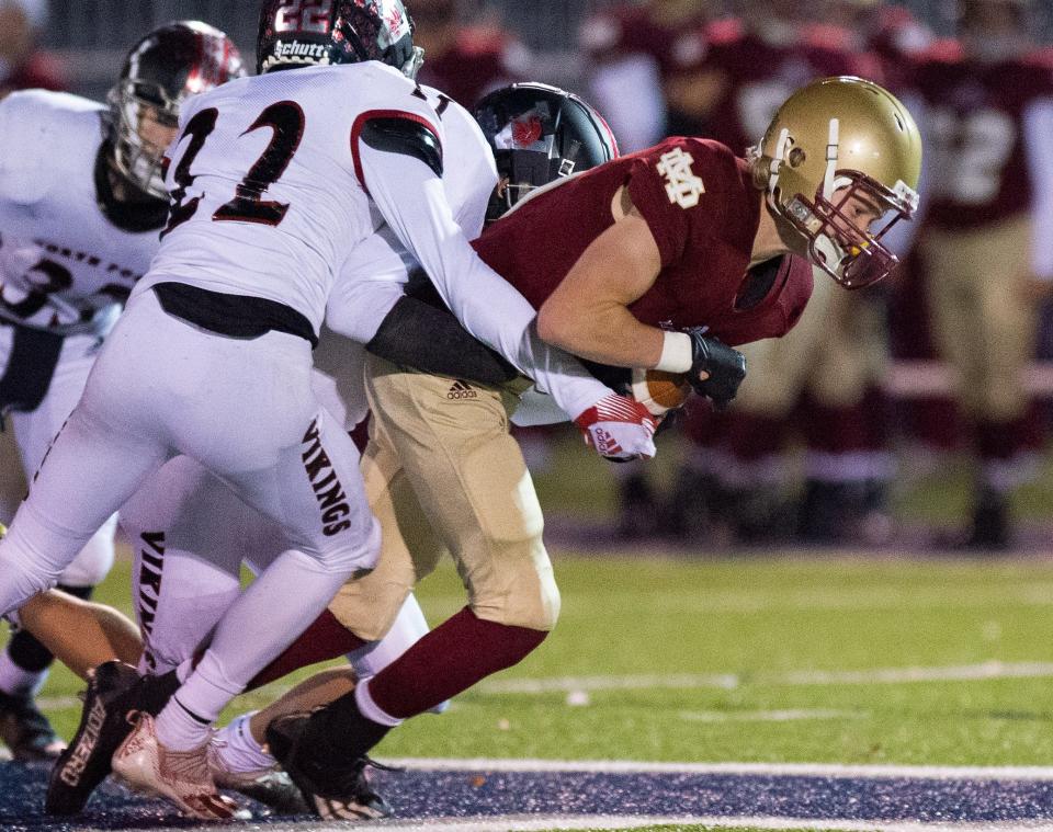 Mater Dei's Ethan Stolz (19) fights for yardage during the football game between the Mater Dei Wildcats and the North Posey Vikings at the Reitz Bowl in Evansville, Ind., Friday evening,  Nov. 5, 2021.