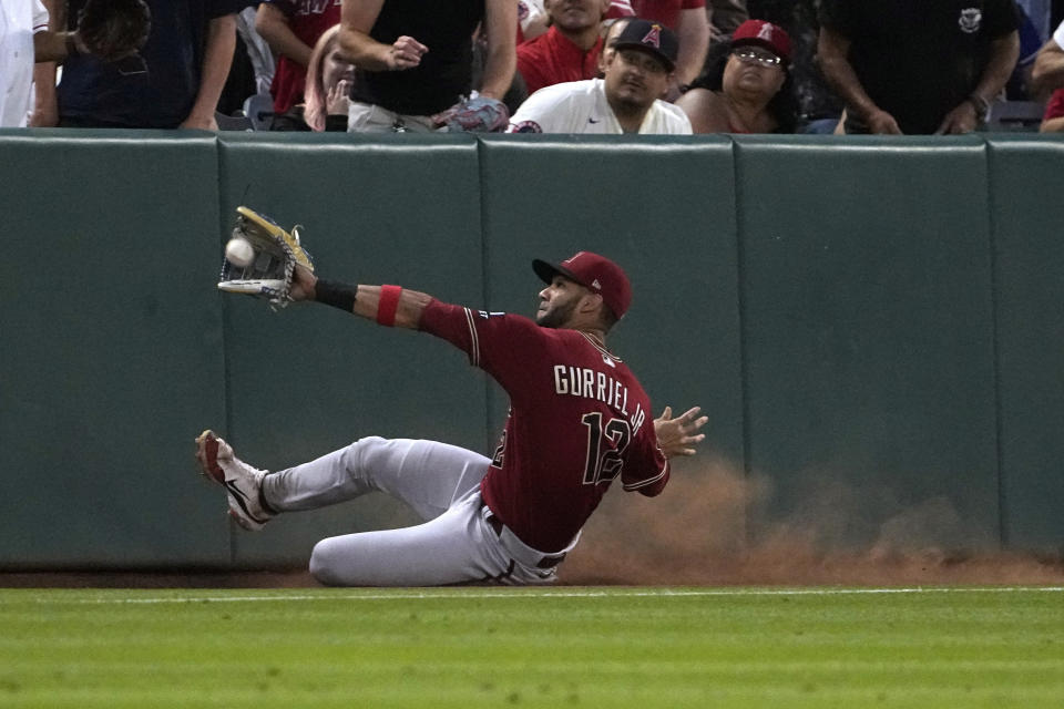 Arizona Diamondbacks left fielder Lourdes Gurriel Jr. makes a catch on a foul ball hit by Los Angeles Angels' Matt Thaiss during the fourth inning of a baseball game Saturday, July 1, 2023, in Anaheim, Calif. (AP Photo/Mark J. Terrill)