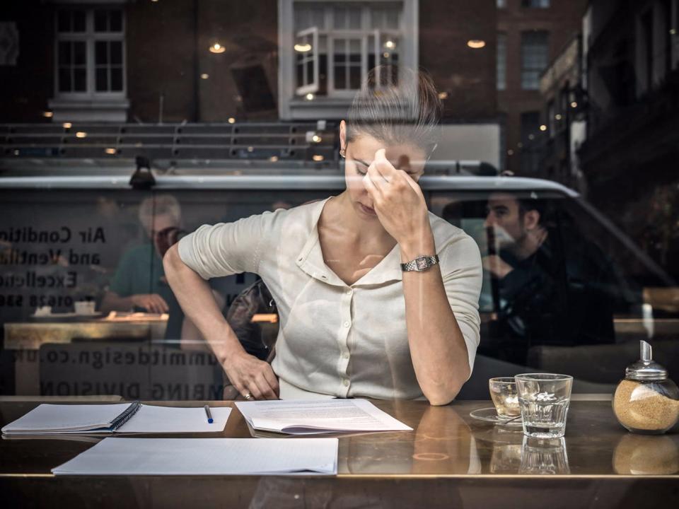 woman and papers stressed