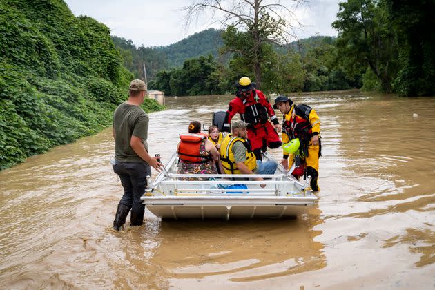 A rescue team from the Jackson Fire Department assists people out of floodwaters downtown Jackson, Kentucky, on July 28. (Photo: Michael Swensen/Getty Images)