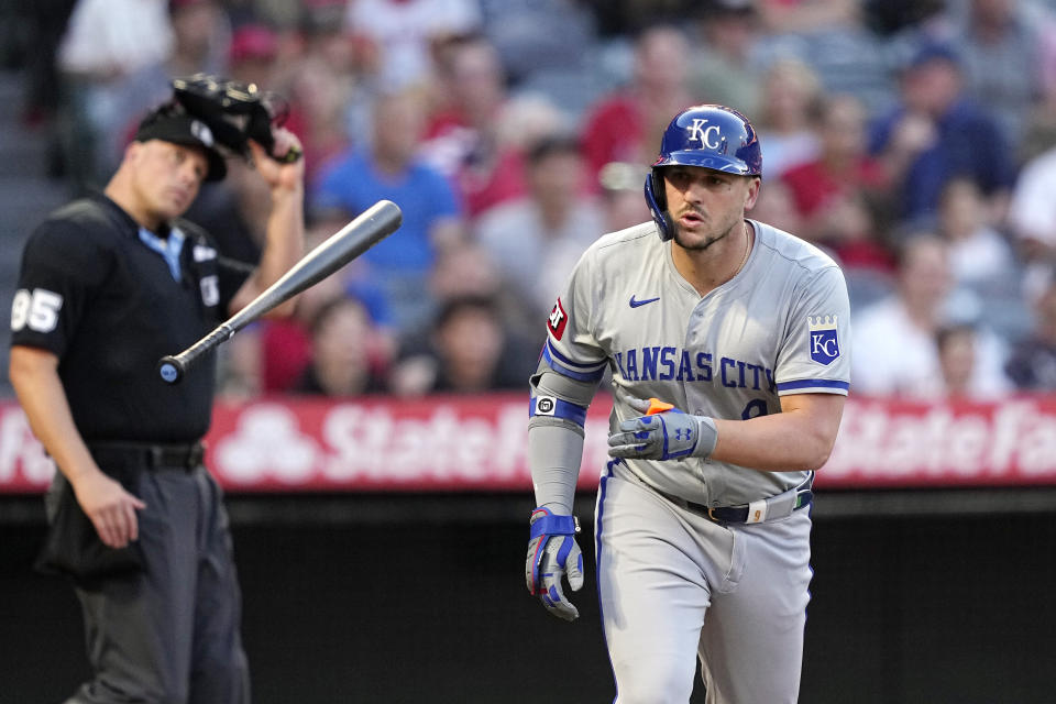 Kansas City Royals' Vinnie Pasquantino, right, tosses his bat as he heads to first after hitting a two-run home run as home plate umpire Stu Scheurwater watches during the third inning of a baseball game against the Los Angeles Angels Thursday, May 9, 2024, in Anaheim, Calif. (AP Photo/Mark J. Terrill)