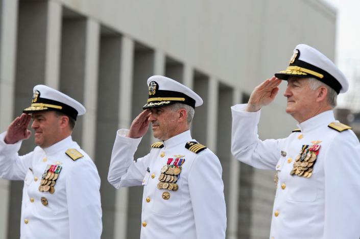 Rear Admirals and a Captain salute national anthem
