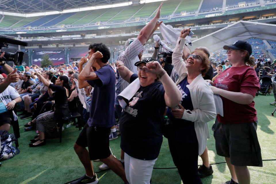 New York Yankees' fans cheer the pick of George Lombard Jr. in baseball's amateur draft, Sunday, July 9, 2023, in Seattle. (AP Photo/John Froschauer)