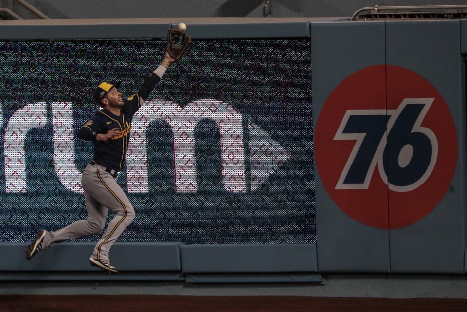 Milwaukee Brewers outfielder Ryan Braun misses a hit by Mookie Betts during the first inning.