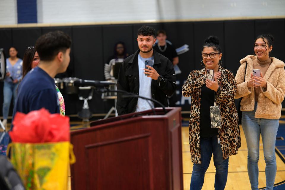 Jorge Merino's family, Gabriel Merino, his brother; Raquel Merino, his mother; and Stephanie Escanilla, his sister, react as he thanks them. OG&E surprised Southeast High School senior Jorge Merino Tuesday with a Positive Energy scholarship to pursue higher education in Oklahoma.