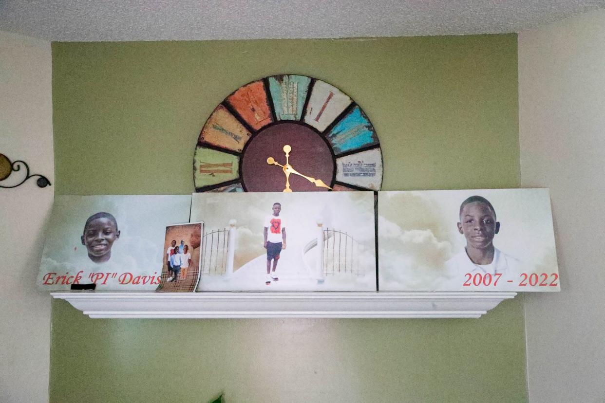 Photos of Erick Davis sit on the mantle in the living room of his home.