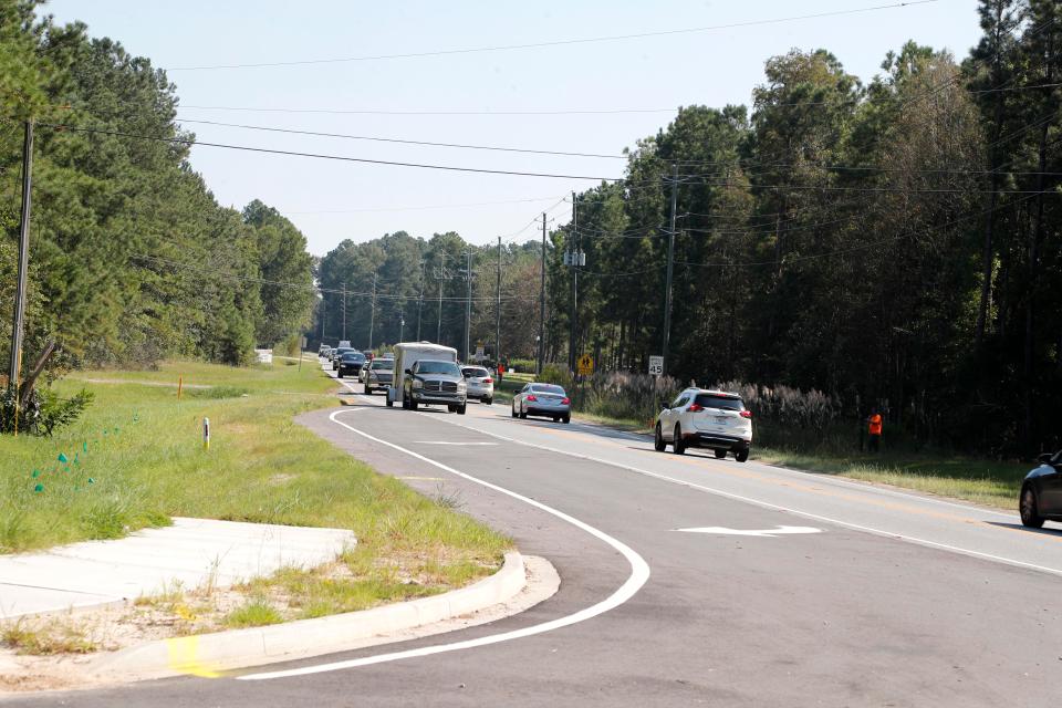 Traffic moves along a two-lane portion of Pooler Parkway.