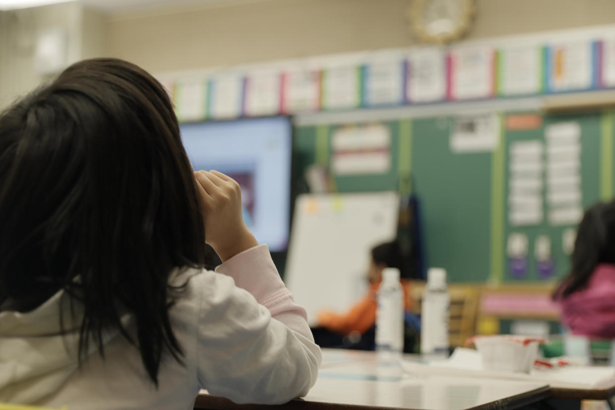 A masked student sits in a classroom at Yung Wing School P.S. 124 in New York City. 