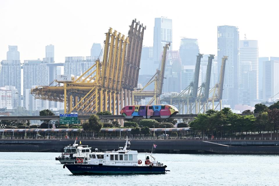 The giant sea port cranes of Tanjung Pagar container terminal and the high rise buildings of financial business district of Singapore is seen on March 14, 2019. (Photo by Roslan RAHMAN / AFP)        (Photo credit should read ROSLAN RAHMAN/AFP/Getty Images)