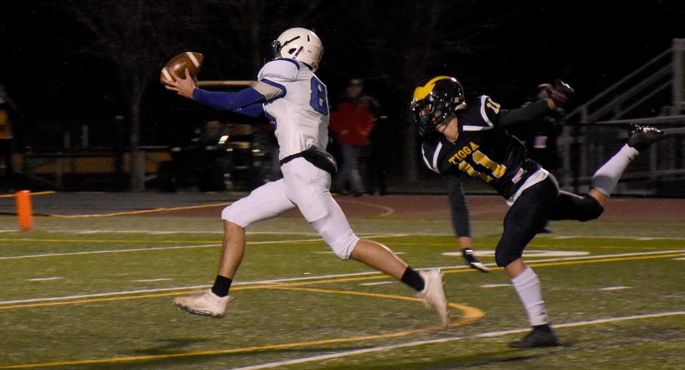 Dolgeville Blue Devil Kamryn Comstock (left) grabs a touchdown pass against Tioga during the 2021 regional Class D playoff game in Vestal. Comstock leads Dolgeville with eight receiving touchdowns as a senior.