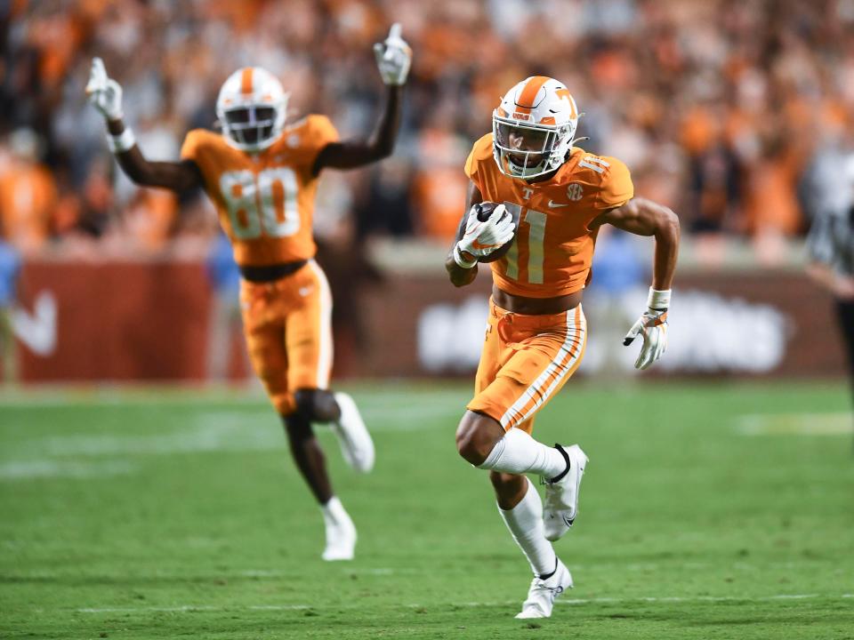 Tennessee wide receiver Jalin Hyatt (11) returns the ball 41 yards for a touchdown against Akron during an NCAA college football game against on Saturday, September 17, 2022 in Knoxville, Tenn. Cheering him on at left is Tennessee wide receiver Ramel Keyton (80). 