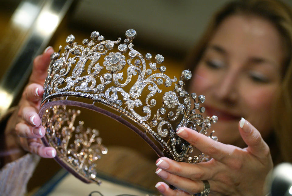 hands holding up the tiara