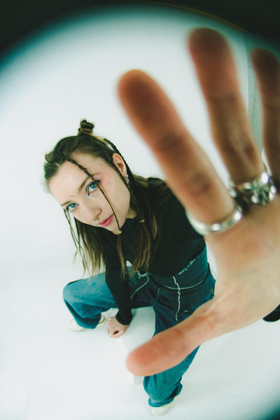 Woman putting her hand up to the camera 