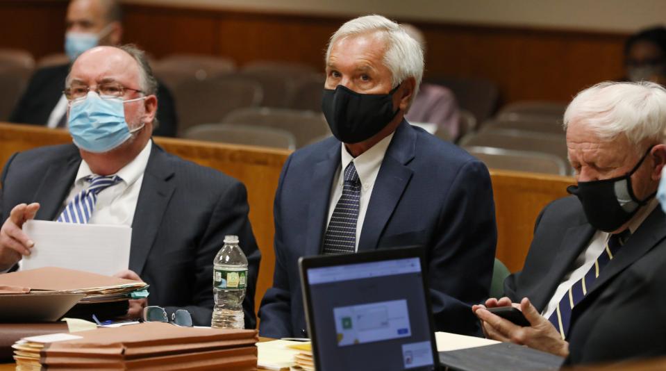 James Krauseneck Jr., center, sits with his attorneys William Easton, left, and Michael Wolford, right, during their Singer hearing at the Hall of Justice in downtown Rochester Tuesday, June 22, 2021.