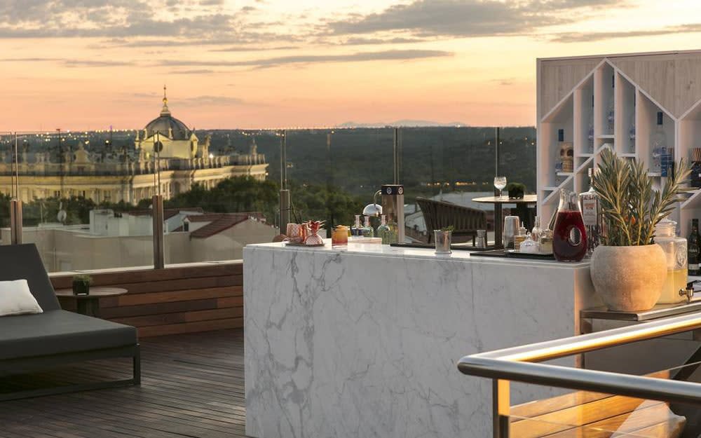 The rooftop bar and pool at Gran Meliá Palacio de los Duques has panoramic views across the city to the mountains