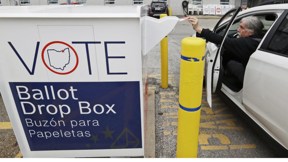 A voter drops of his election ballot in the drop box at the Cuyahoga County Board of Elections in April, in Cleveland, Ohio. (Tony Dejak/AP)