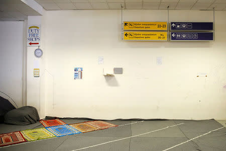 Praying mats are laid on the floor at the old terminal of the disused Hellenikon airport, where refugees and migrants are temporarily housed, in Athens, Greece, July 13, 2016. Picture taken July 13, 2016. REUTERS/Alkis Konstantinidis