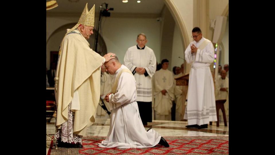 Father Elkin Sierra is blessed by Archbishop Thomas Wenski during his ordination at St. Mary’s Cathedral in Miami on Saturday May 11, 2019.