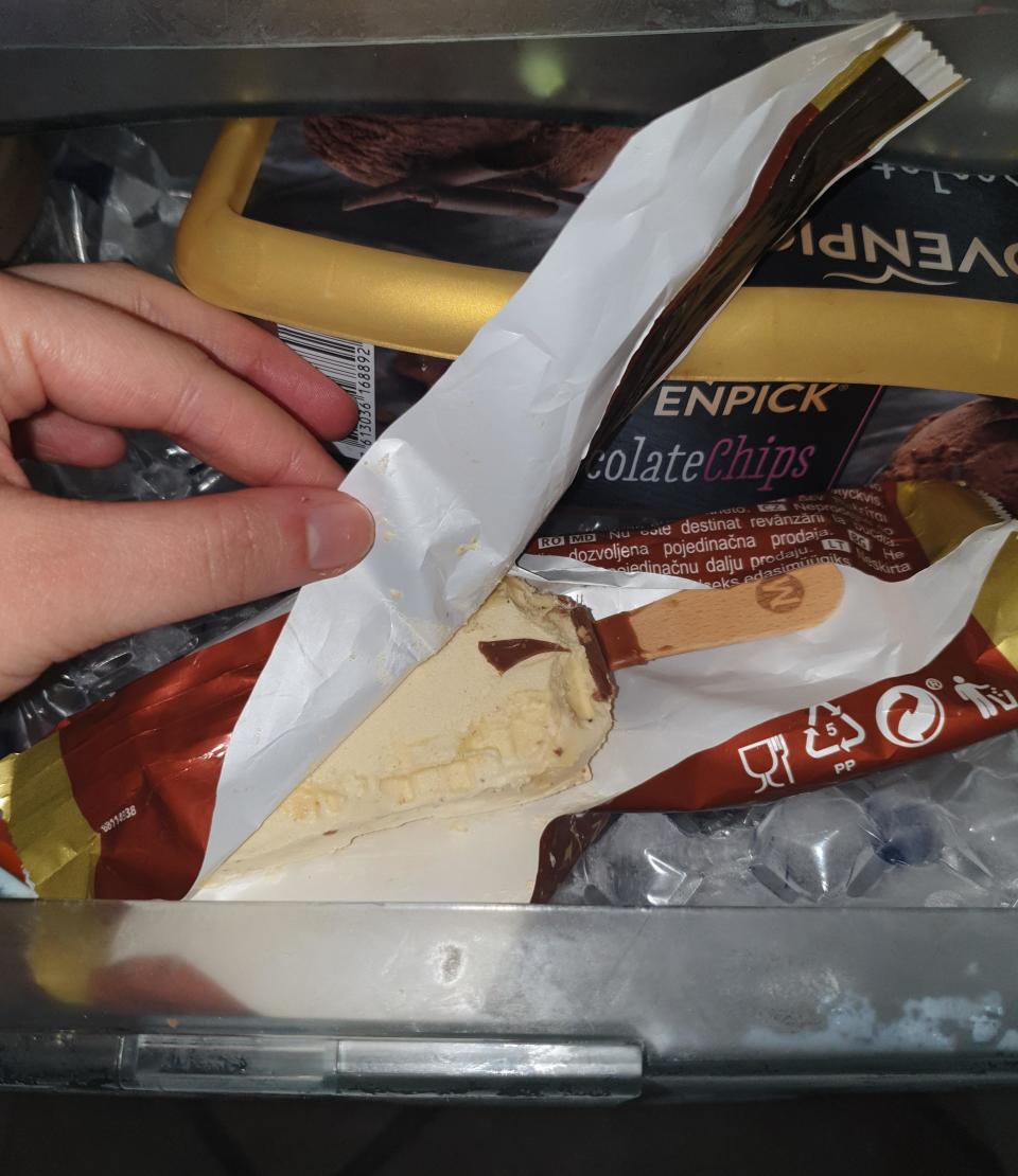 Woman looking at ice cream in the fridge