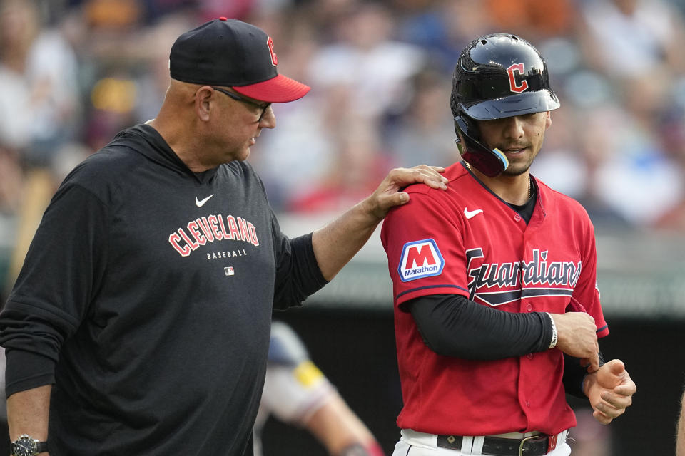 Cleveland Guardians manager Terry Francona, left, checks on Andres Gimenez after Gimenez was hit by an Atlanta Braves pitch during the third inning of a baseball game Wednesday, July 5, 2023, in Cleveland. (AP Photo/Sue Ogrocki)