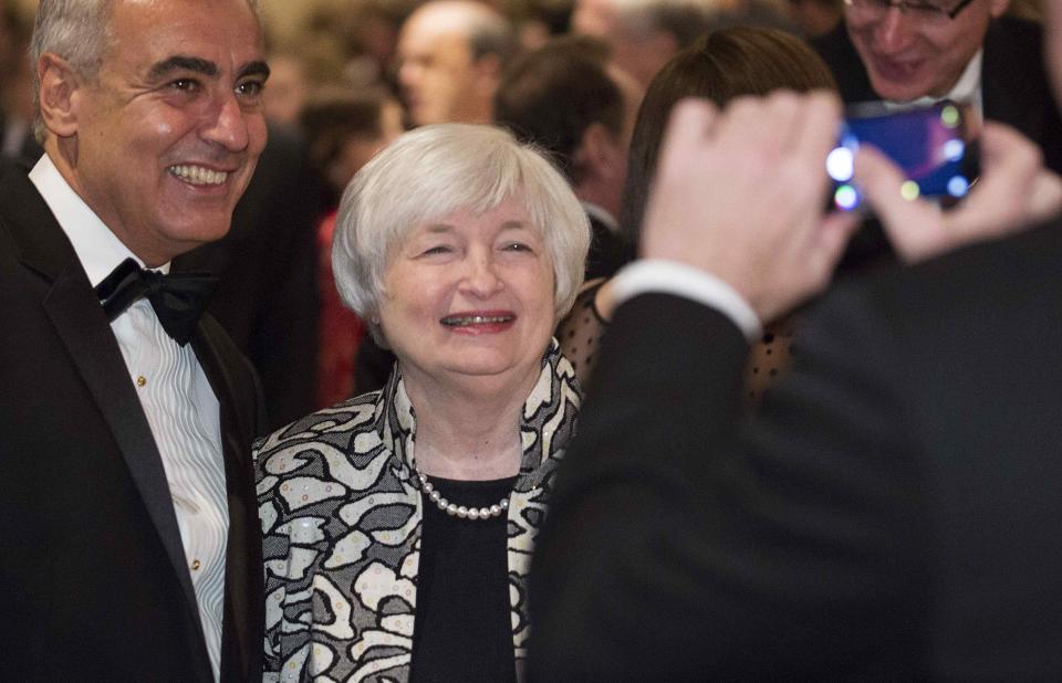 Chair of the U.S. Federal Reserve Janet Yellen (2nd L) poses for a picture with a guest at the White House Correspondents' Association Dinner in Washington on May 3, 2014. (REUTERS/Joshua Roberts)