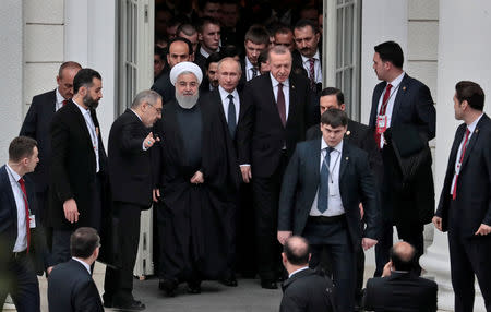 Iranian President Hassan Rouhani, Russian President Vladimir Putin and Turkish President Recep Tayyip Erdogan walk during their meeting in the Black sea resort of Sochi, Russia, 14 February 2019. Sergei Chirikov/Pool via REUTERS