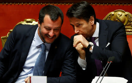 Deputy Prime Minister Matteo Salvini speaks with Italian Prime Minister Giuseppe Conte in the upper house of the Italian parliament, in Rome, Italy March 20, 2019. REUTERS/Yara Nardi