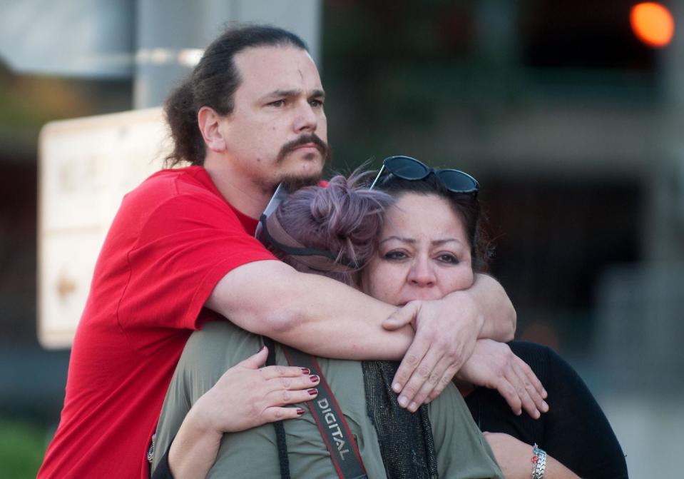 Shocked supporters of Kelly Thomas react Monday Jan. 13, 2014, outside the Santa Ana Courthouse, after the 'not guilty' verdicts in his beating death. The Orange County panel on Monday found Manuel Ramos and Jay Cicinelli not guilty of all charges — including manslaughter — in the 2011 death of Kelly Thomas. A surveillance video showed police pummeling and stun-gunning him. (AP Photo/ The Orange County Register, Eugene Garcia)