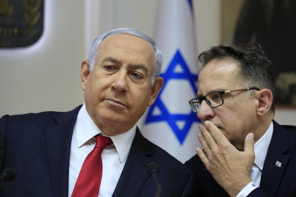 Israeli Prime Minister Benjamin Netanyahu, left, listens to Cabinet Secretary Tzachi Braverman during the weekly cabinet meeting at the Prime Minister's office in Jerusalem, Sunday, May 19, 2019. (AP Photo/Ariel Schalit, Pool)