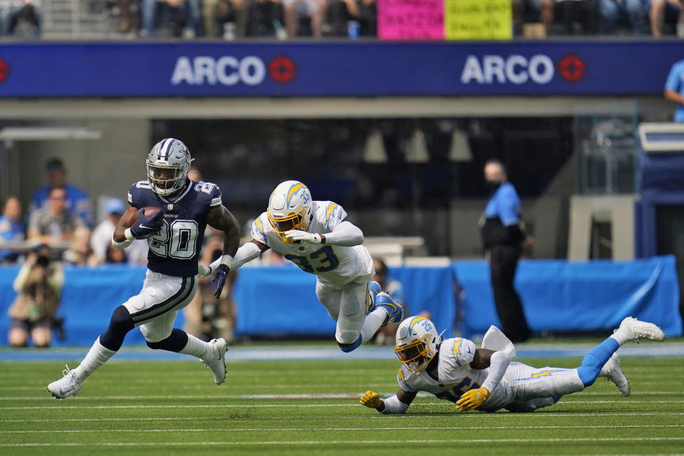 Dallas Cowboys running back Tony Pollard (20) runs past Los Angeles Chargers free safety Derwin James (33) during the first half of an NFL football game Sunday, Sept. 19, 2021, in Inglewood, Calif. (AP Photo/Gregory Bull )