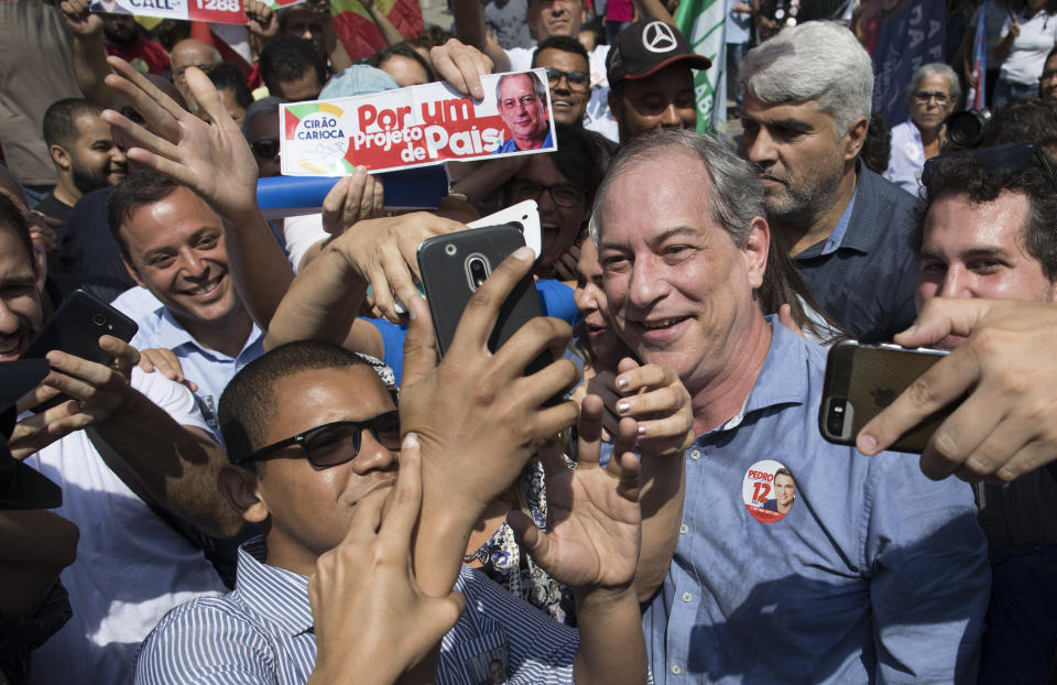 Ciro Gomes, presidential candidate with the Democratic Labor Party, poses for selfies with a supporters as he campaigns in downtown Rio de Janeiro, Brazil, Wednesday, Sept. 12, 2018. Brazil will hold general elections on Oct. 7. (AP Photo/Leo Correa)