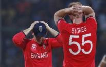 Cricket - England v New Zealand - World Twenty20 cricket tournament semi-final - New Delhi, India - 30/03/2016. England's captain Eoin Morgan (L) and his teammate Ben Stokes react after a missed run out chance. REUTERS/Adnan Abidi