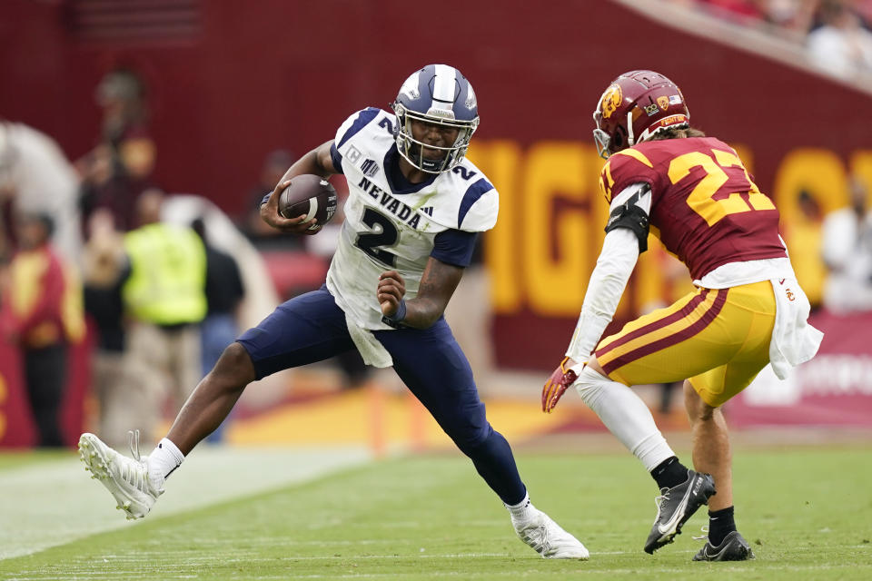 Nevada quarterback Brendon Lewis (2) attempts to run past Southern California safety Bryson Shaw (27) during the second half of an NCAA college football game, Saturday, Sept. 2, 2023, in Los Angeles. (AP Photo/Ryan Sun)