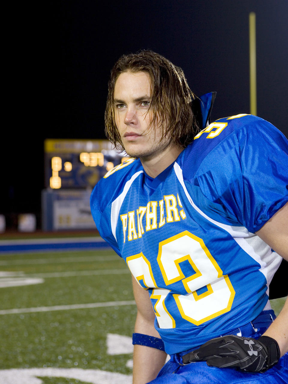 Taylor Kitsch in a football uniform