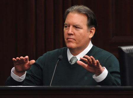 Defendant Michael Dunn gestures on the stand during testimony in his own defense during his murder trial in Duval County Courthouse in Jacksonville, Florida February 11, 2014. REUTERS/Bob Mack/Pool