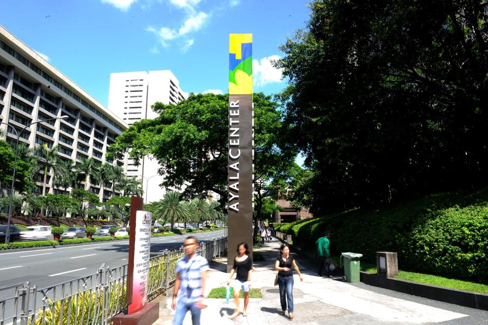 File Photo: People walk at Ayala Corp's Ayala Center in Manila on August 12, 2011. (Photo: JAY DIRECTO/AFP via Getty Images)