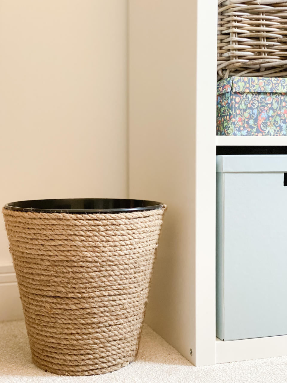 A waste bin covered in corded rope