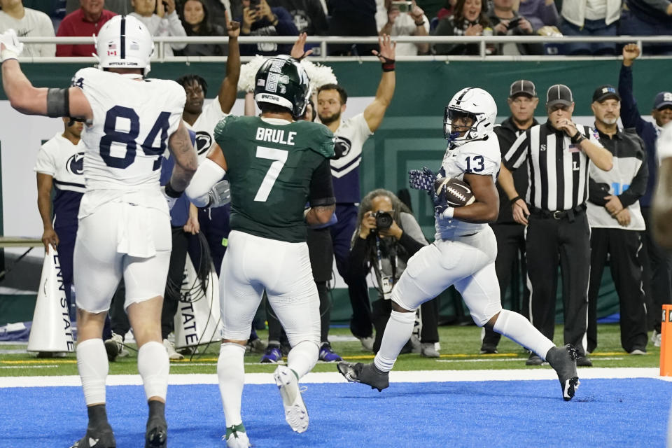 Penn State running back Kaytron Allen (13) crosses into the endzone for a touchdown during the first half of an NCAA college football game against Michigan State, Friday, Nov. 24, 2023, in Detroit. (AP Photo/Carlos Osorio)