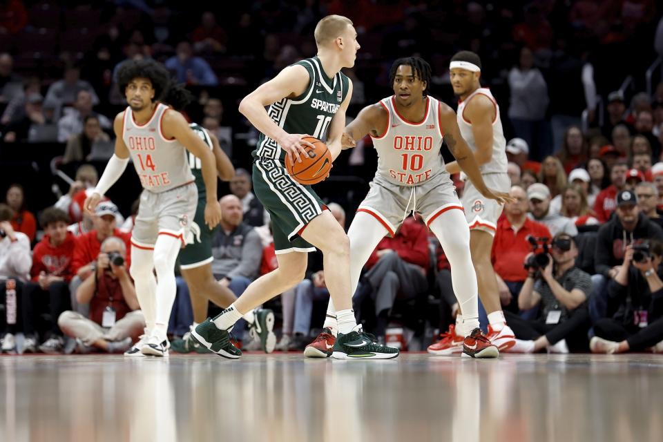 Brice Sensabaugh (10) of the Ohio State Buckeyes defends against Joey Hauser (10) of the Michigan State Spartans during the first half of the game at the Jerome Schottenstein Center on February 12, 2023 in Columbus, Ohio.
