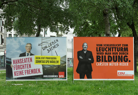 Election poster showing top candidates Carsten Meyer-Heder of Germany's Christian Democrats Union (CDU) and Carsten Sieling of the Social Democrats (SPD), are pictured during German city-state of Bremen parliamentary elections in Bremen, Germany May 26, 2019. REUTERS/Fabian Bimmer